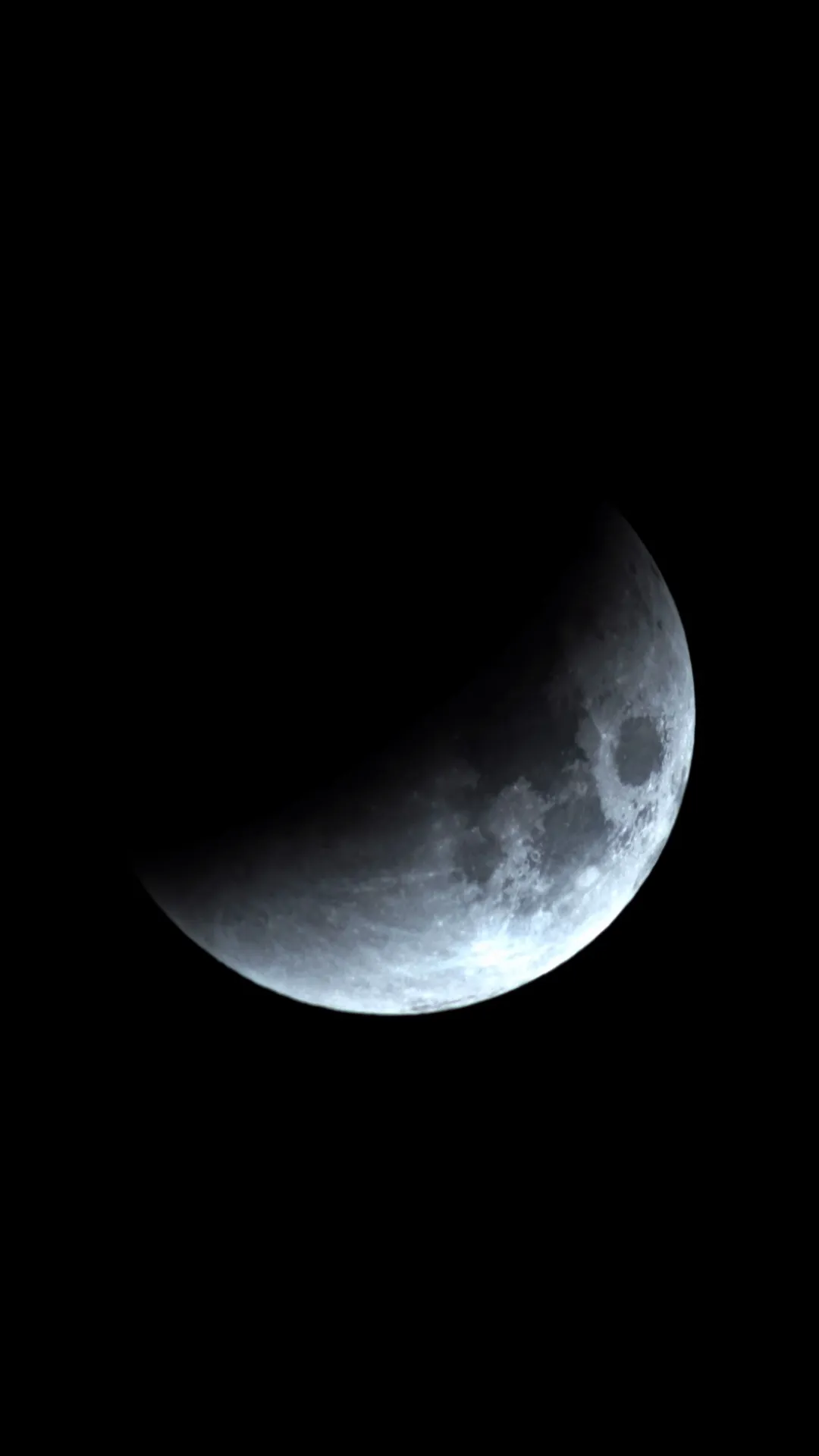 A crescent-phase Moon with sharply detailed craters along the terminator
